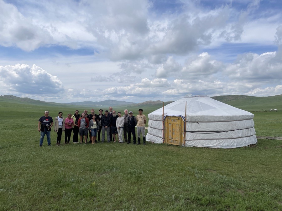 Tuul Travel founder Maamkhuu with travelers in front of a white ger